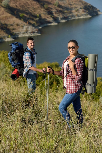 Girl and man posing in the mountains.