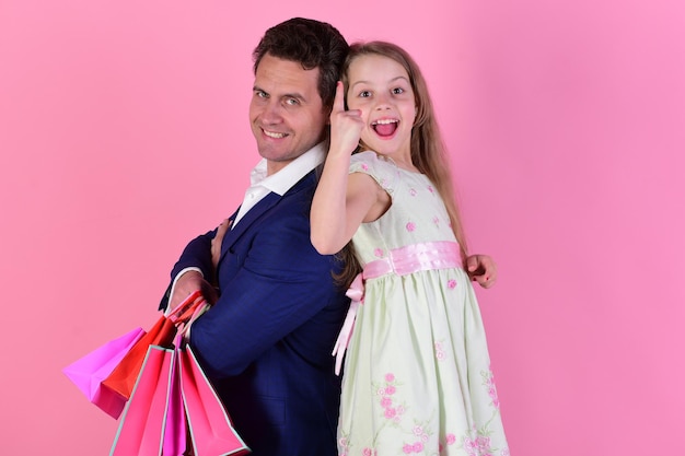 Girl and man with excited faces stand back to back