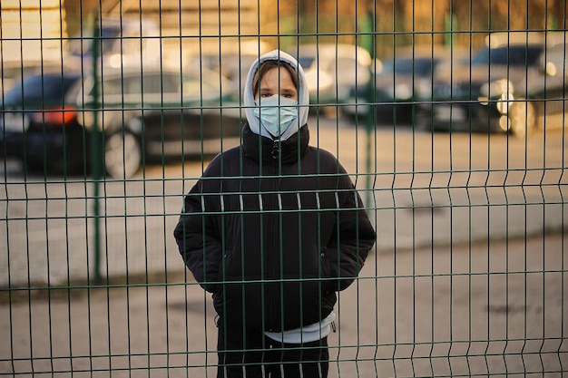 girl in a medical mask in the quarantine zone COVID19 Quarantine coronavirus pandemic