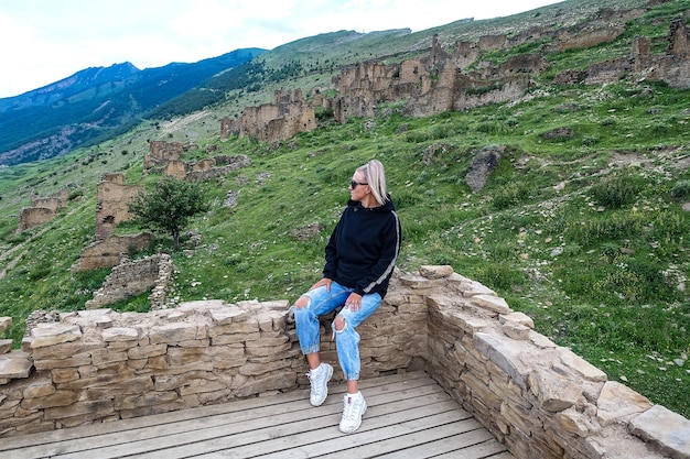 A girl on medieval defensive towers in the village of Goor Russia Dagestan 2021