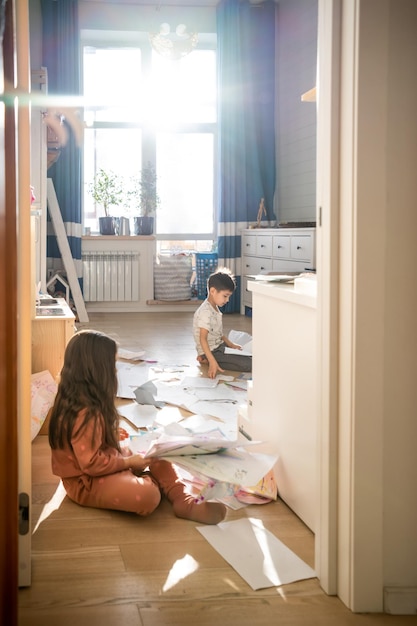 A girl among the mess and scattered sheets in the room