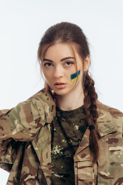 Photo girl in military uniform ukrainian flag of ukraine on the face war in ukraine bucha on a white background