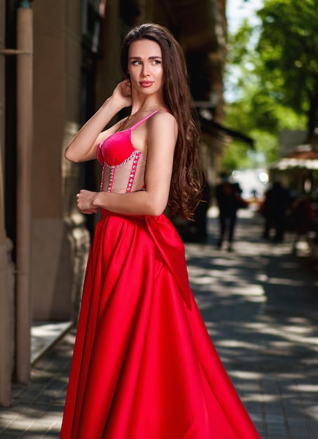 Girl model in a white dress on the street