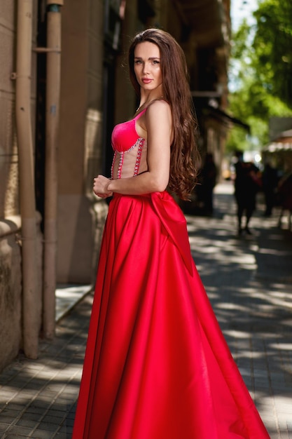 Girl model in a white dress on the street