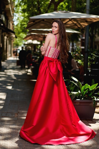 Girl model in a white dress on the street