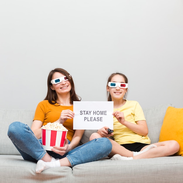 Girl and mom watching movie at home