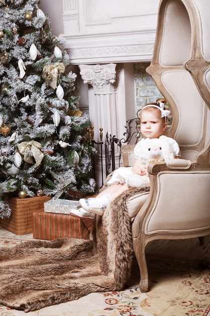 Girl near cristmass tree, holiday picture