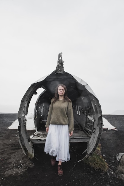 girl near The plane on Solheimasandur in Iceland