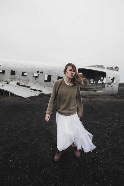 girl near The plane on Solheimasandur in Iceland