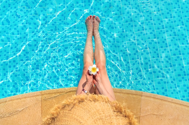 Girl near the pool with a flower