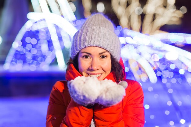 Girl in a night city snowflake Christmas city lights. Christmas and winter holidays concept.