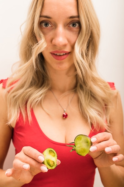 Girl nutritionist sits at a table with vegetables