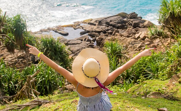 Girl on the ocean in a hat