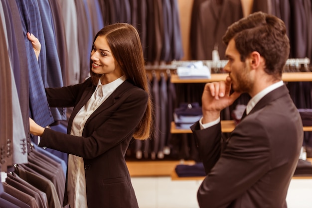 The girl offers this suit to a man.