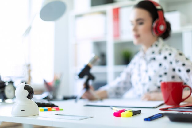 Girl in the office with markers and calculator.