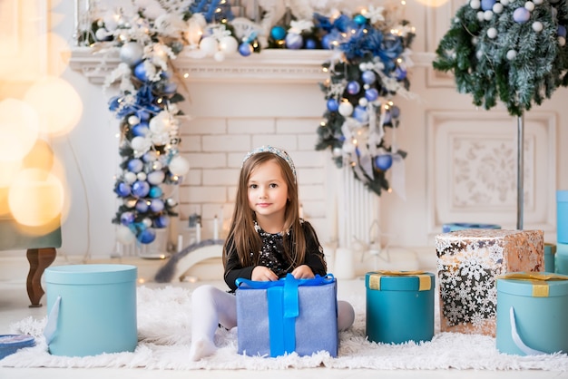 Girl opens a Christmas gift.