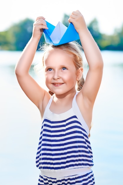 Photo girl and origami boat outdoor