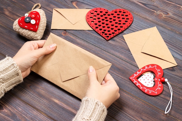 Girl packs a love letter for Valentine's Day. Valentine day concept with copyspace