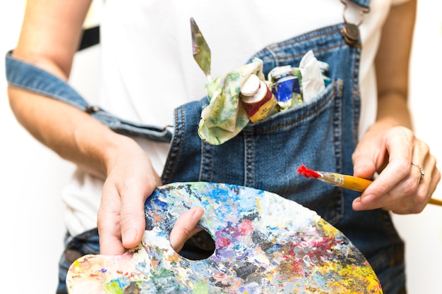 Girl painter holds a brush