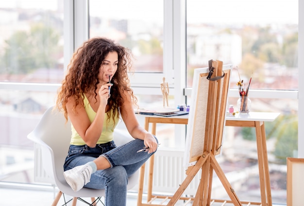 Girl painter thinking of what to paint