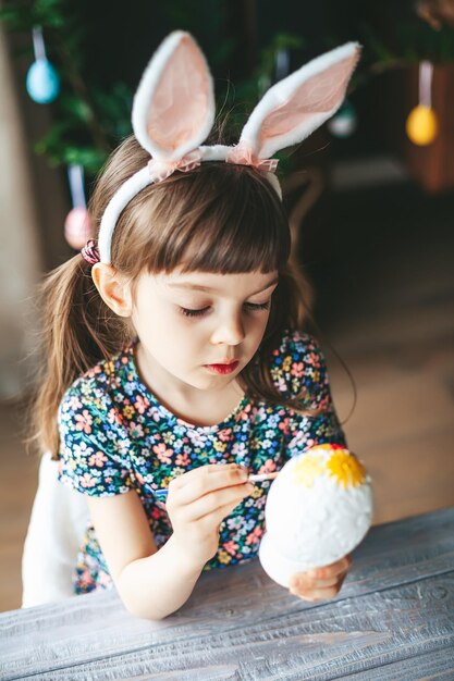 Girl painting Easter egg