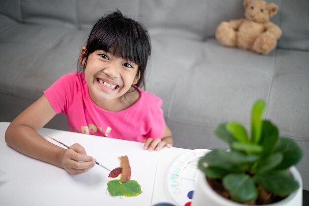 Girl Painting Picture On Table At Home