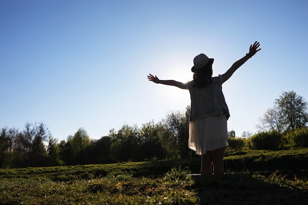 Girl in the park in the evening of a sunny day in the spring