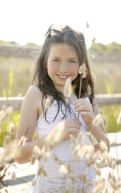 Girl at the park playing with flower spike