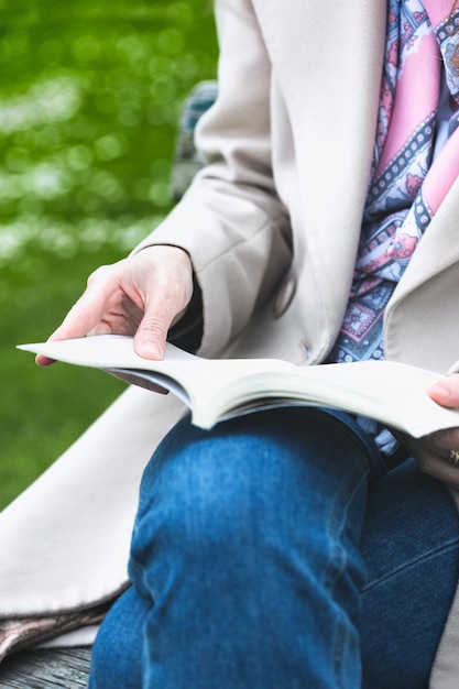 Girl at the park reading a book