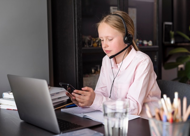 Girl participating in online class indoors