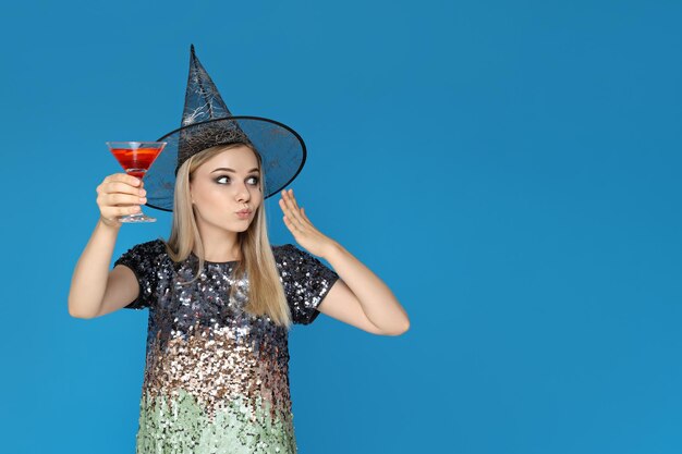 A girl at a party in the style of Halloween with a cocktail in her hands