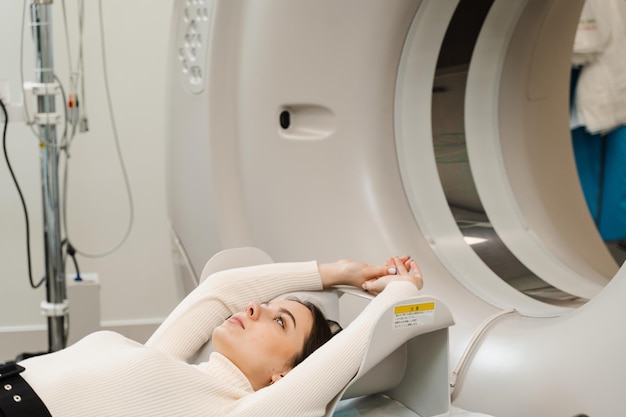 Girl patient lies on computed tomography bed and scanning lungs for diagnose lung cancer in medical clinic CT xray examination of lung cancer in medical clinic