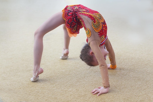 Girl perform exercises in rhythmic gymnastics.