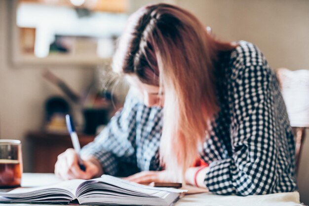 Girl performs a school task at homedistance learning during the coronavirus pandemic