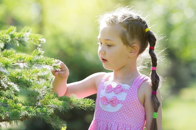  girl in a pink dress in the forest.