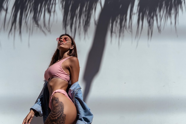 Girl in a pink swimsuit on the beach