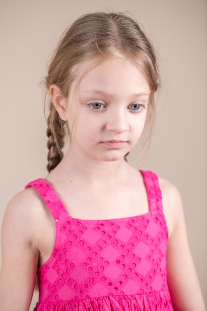 Girl in a pink tank top with the letter g on it