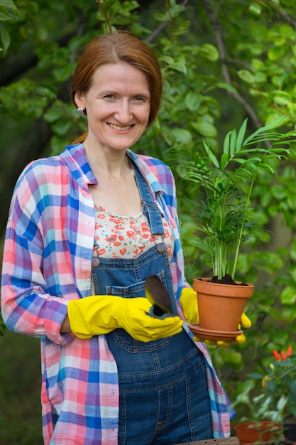 Girl plants a plant