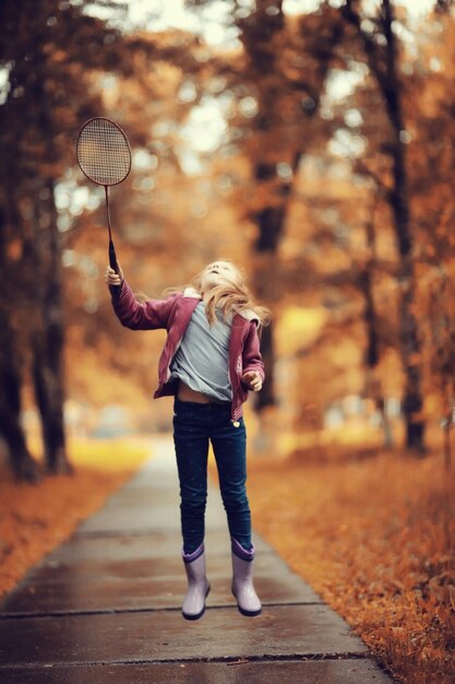 girl playing badminton in the park