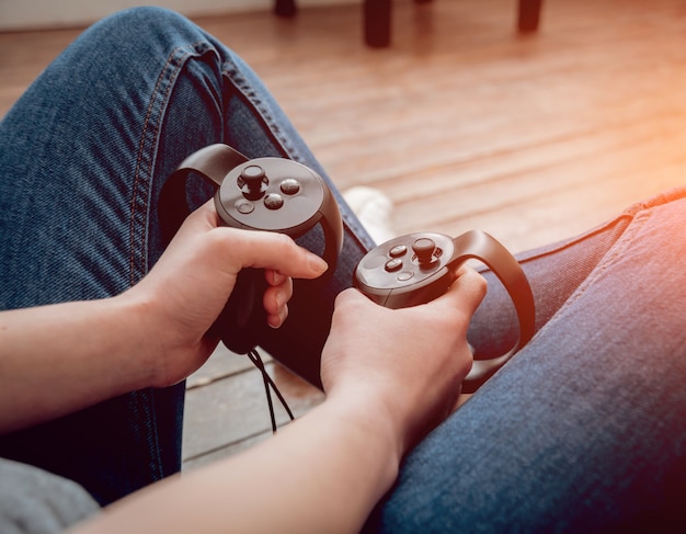 The girl playing games with virtual reality joysticks