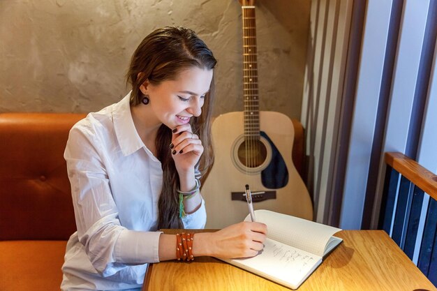 Girl playing guitar at cafe