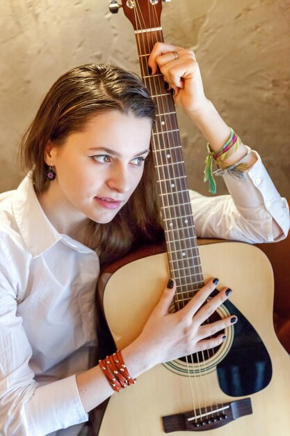 Girl playing guitar at cafe