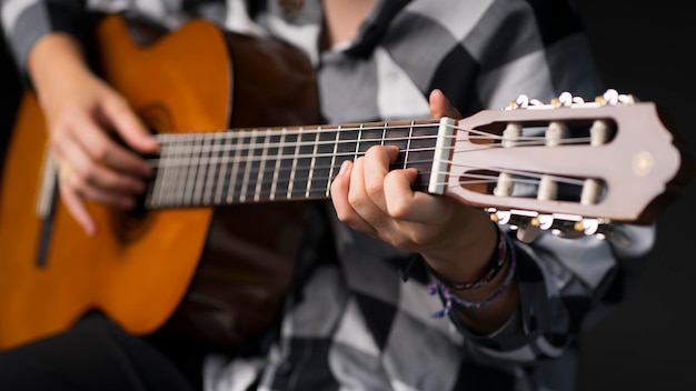 Girl playing the guitar. Image with selective focus