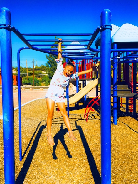 Girl playing at jungle gym