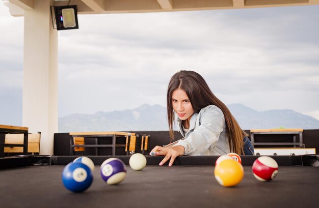 girl playing pool in the garden