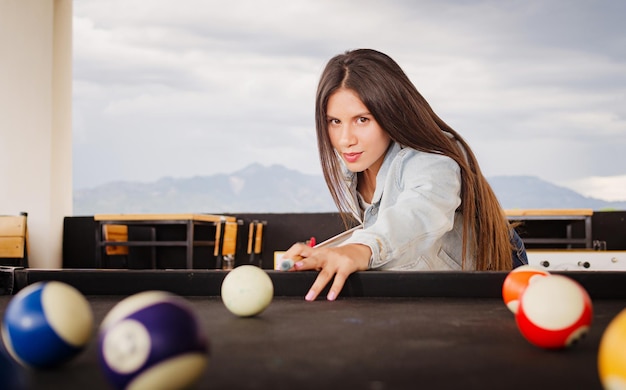 girl playing pool in the garden