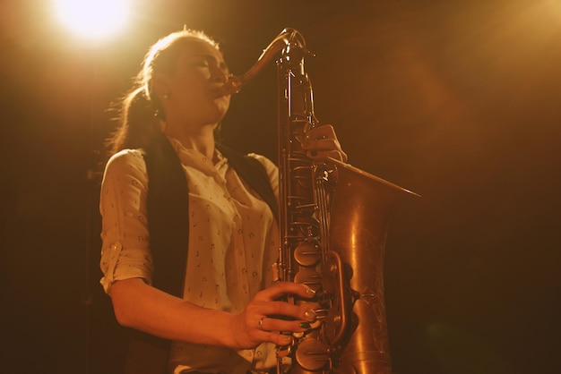 The girl playing the saxophone