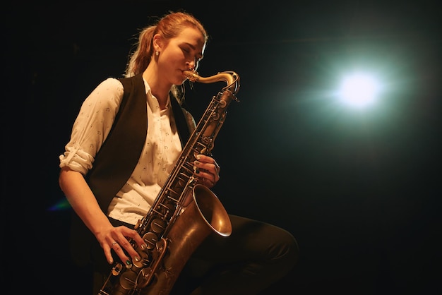 The girl playing the saxophone