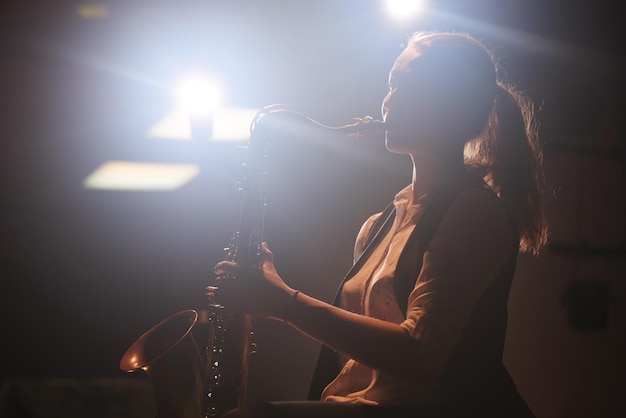 The girl playing the saxophone