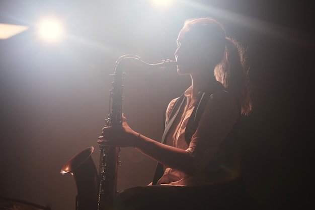 The girl playing the saxophone